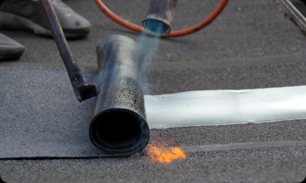 Modified bitumen roof being laid with a live torch