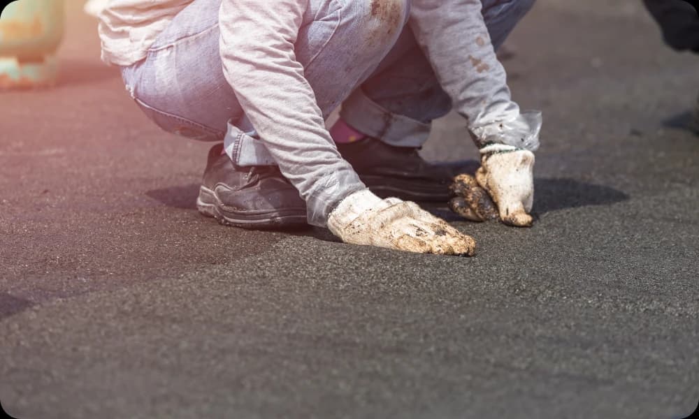 A worker maintaining their flat roof 
