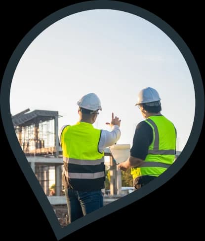 two architects on site looking at a new building in the distance