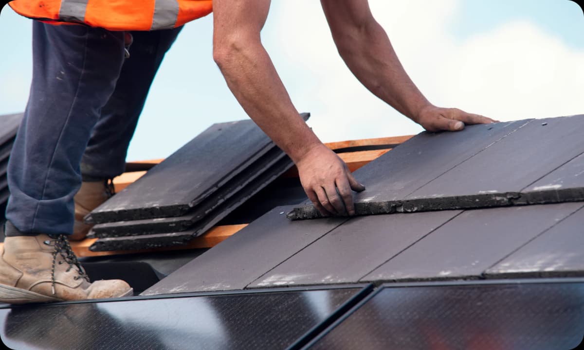 Roofer neatly securing a a tile on top of a roof