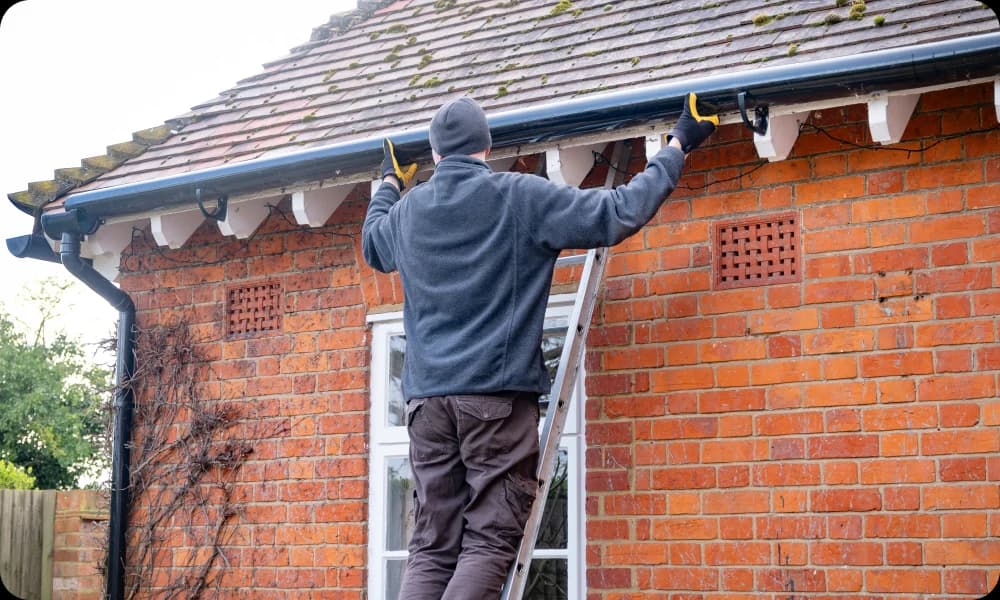 expert fixing some fittings after gutter cleaning