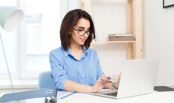 Woman working on laptop at desk