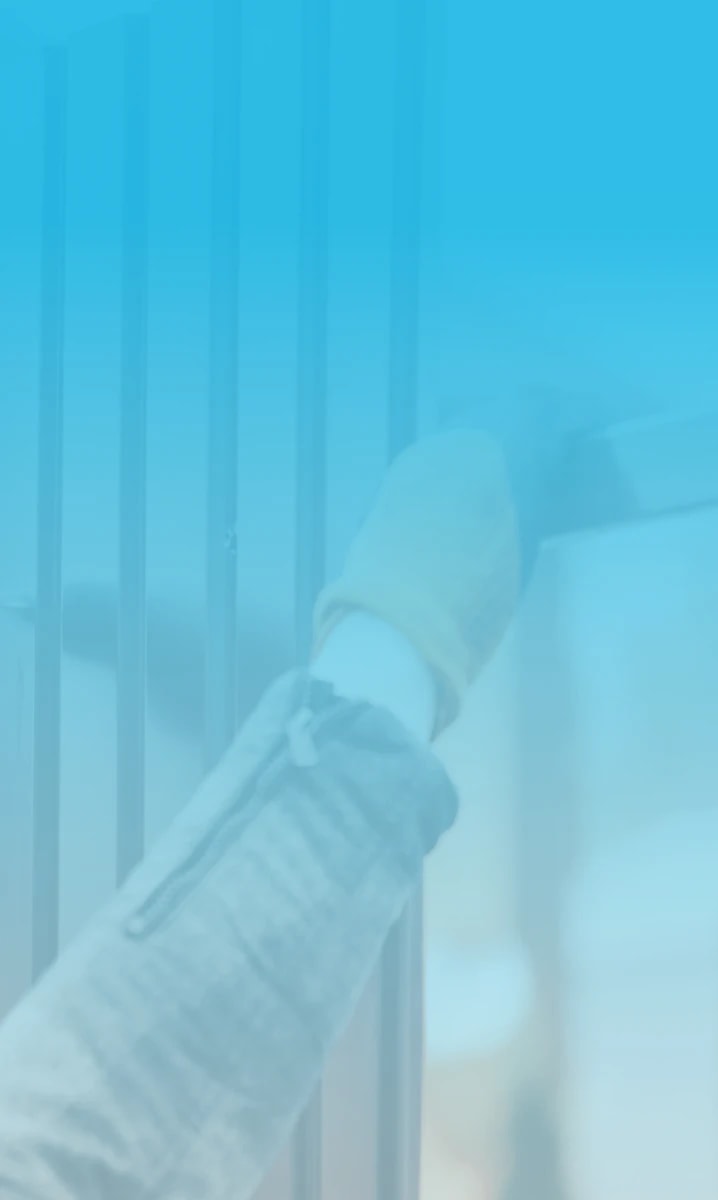 Worker drilling metal fence panel