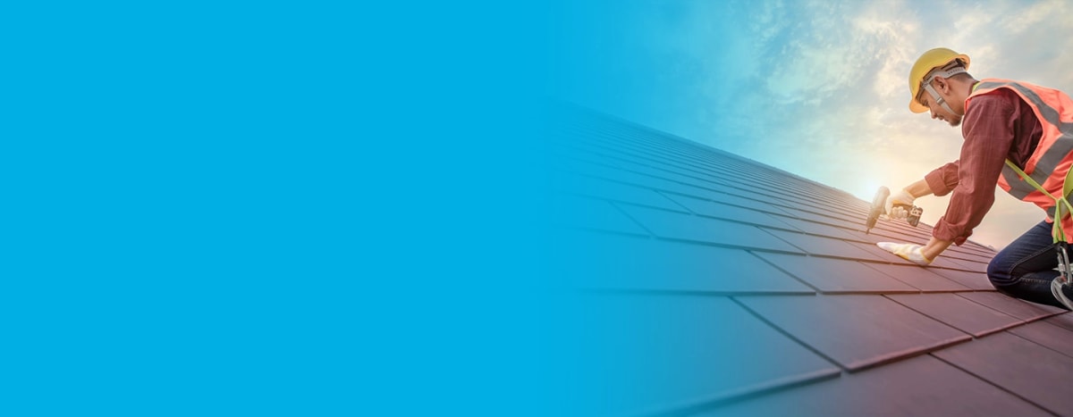 Professional roofers roofing a new build with ceramic roof tiles