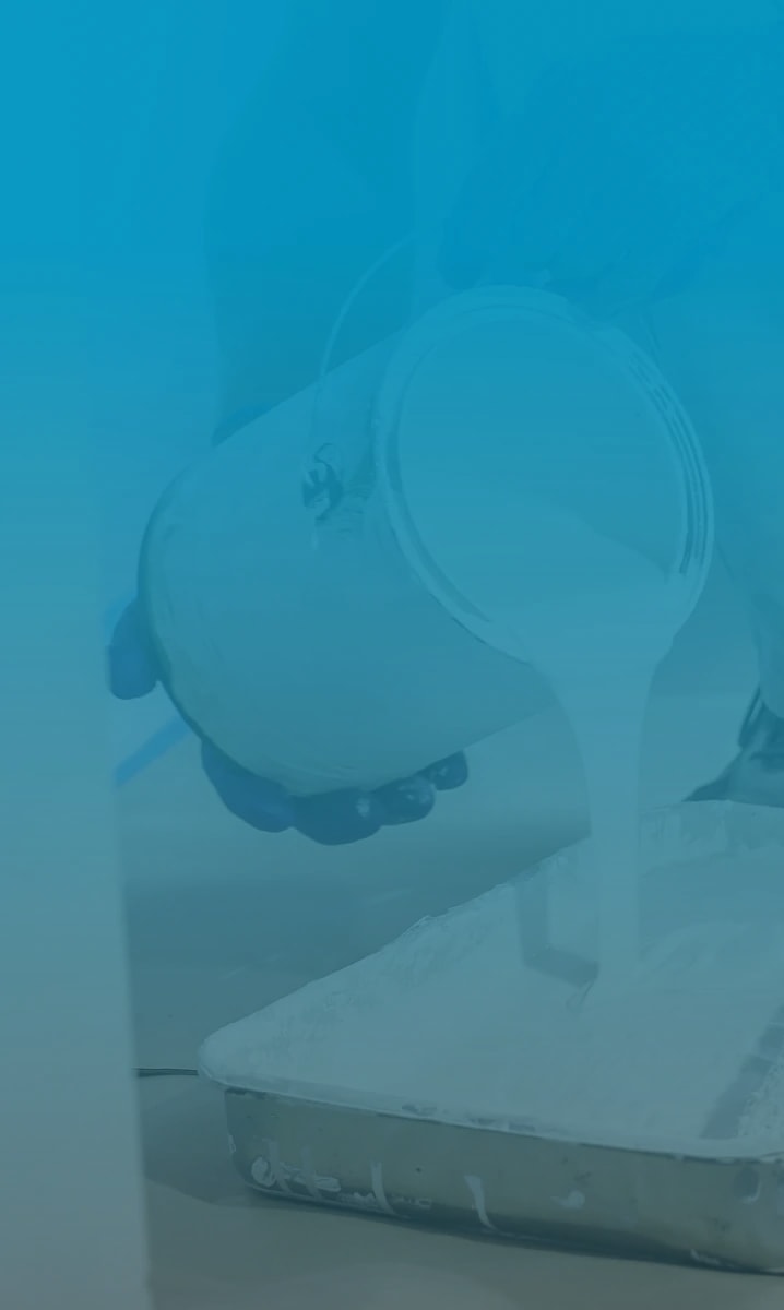 Painter pouring paint into a paint tray with clips roller